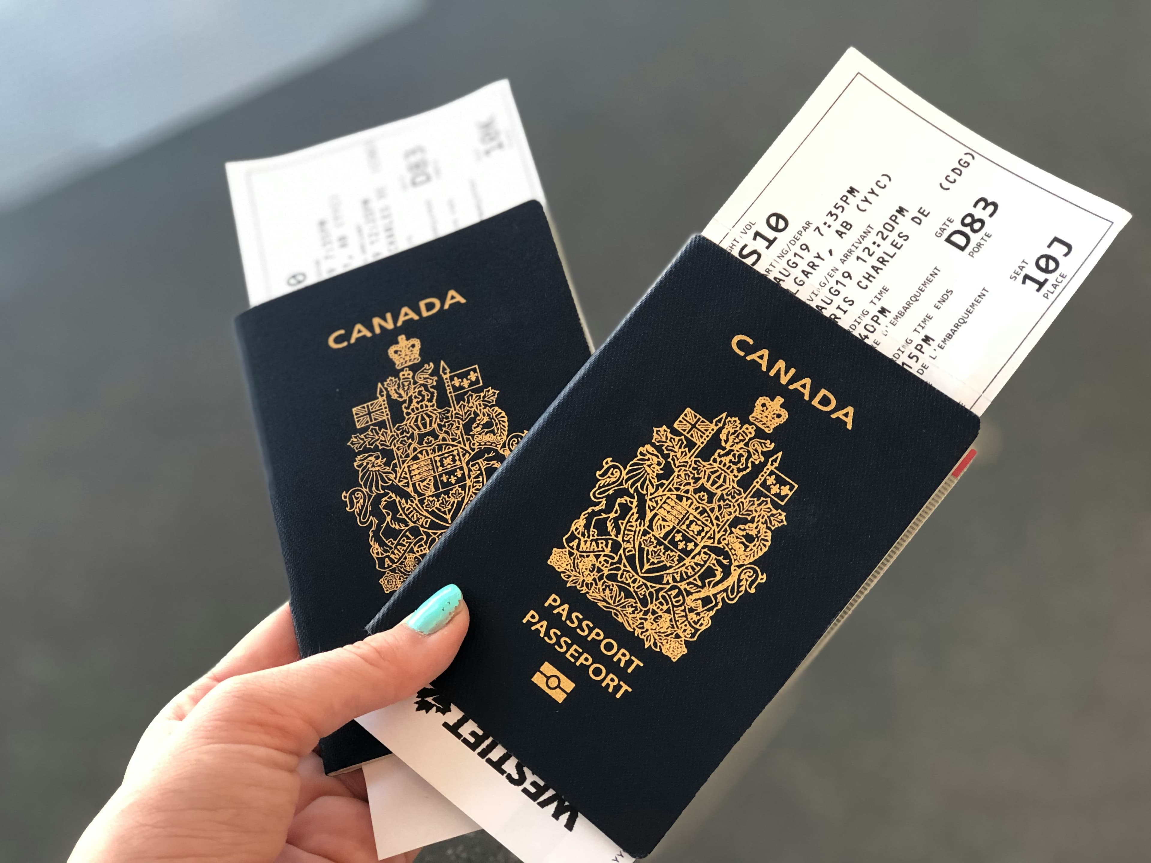 Traveler holding passports used for visa application proof of onward travel